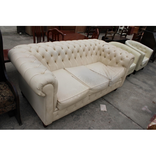 2962 - A MODERN CREAM FAUX LEATHER CHESTERFIELD THREE SEATER SETTEE