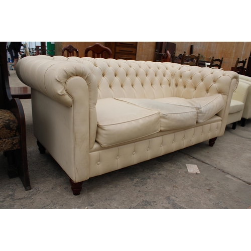 2962 - A MODERN CREAM FAUX LEATHER CHESTERFIELD THREE SEATER SETTEE