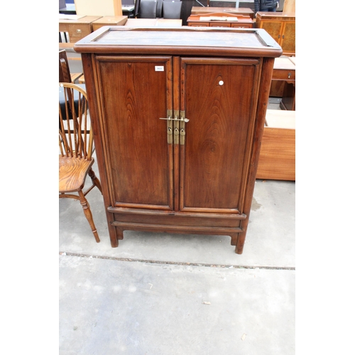 3022 - A CHINESE ELM TAPERING TWO DOOR CABINET WITH BRASS HANDLES AND LOCK WITH TWO INTERNAL DRAWERS, 36