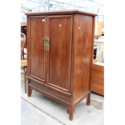 3022 - A CHINESE ELM TAPERING TWO DOOR CABINET WITH BRASS HANDLES AND LOCK WITH TWO INTERNAL DRAWERS, 36