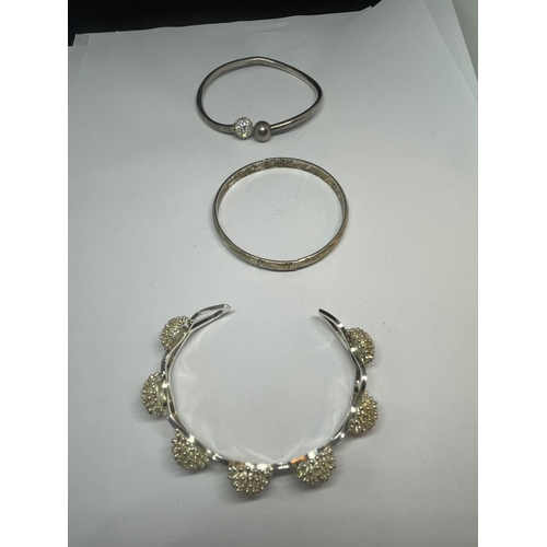 542 - THREE SILVER BANGLES