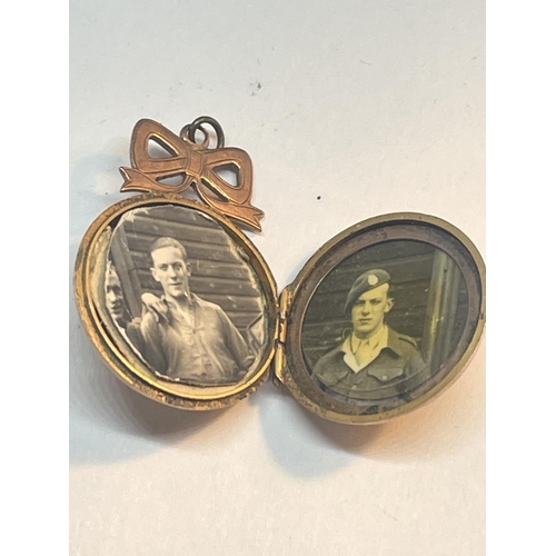 501 - A 9 CARAT GOLD (INDISTINCT HALLMARK) LOCKET WITH BOW DESIGN TO INCLUDE VINTAGE PHOTOGRAPHS GROSS WEI... 