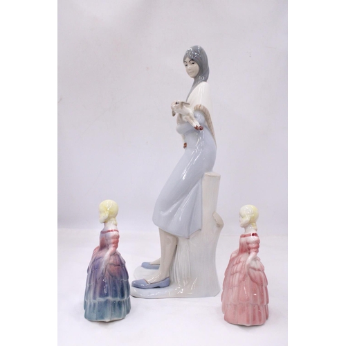 117 - A LLADRO STYLE LADY FIGURE HOLDING A LAMB 38CM TALL, PLUS TWO ROYAL DOULTON STYLE FIGURES