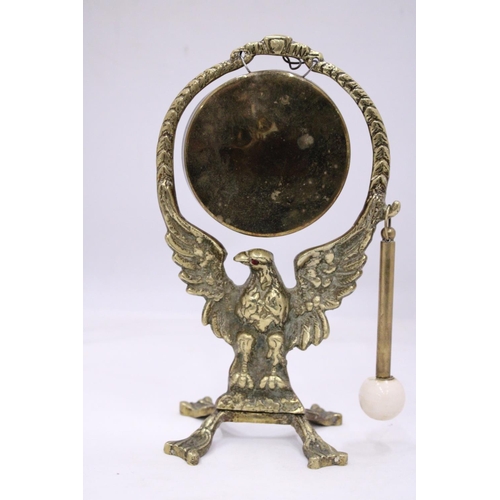 127 - AN ANTIQUE BRASS EAGLE DINNER GONG WITH ORIGINAL STRICKER