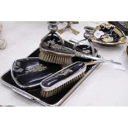 130 - A VINTAGE BLACK DRESSING TABLE VANITY SET TO INCLUDE A HAND MIRROR, TWO BRUSHES AND TRAY - PLUS TWO ... 