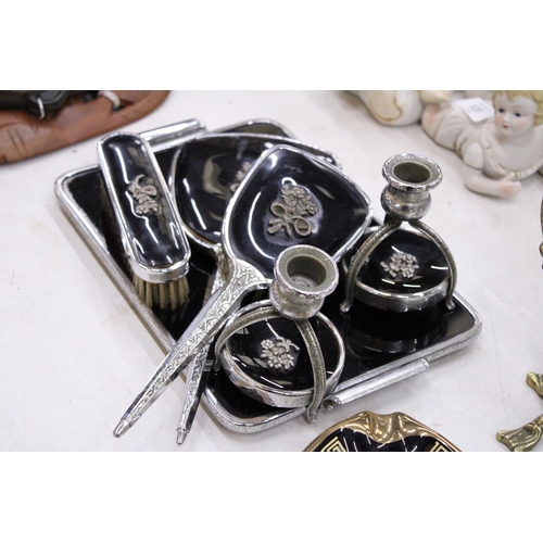 130 - A VINTAGE BLACK DRESSING TABLE VANITY SET TO INCLUDE A HAND MIRROR, TWO BRUSHES AND TRAY - PLUS TWO ... 