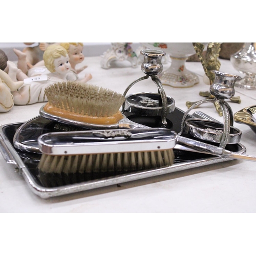 130 - A VINTAGE BLACK DRESSING TABLE VANITY SET TO INCLUDE A HAND MIRROR, TWO BRUSHES AND TRAY - PLUS TWO ... 