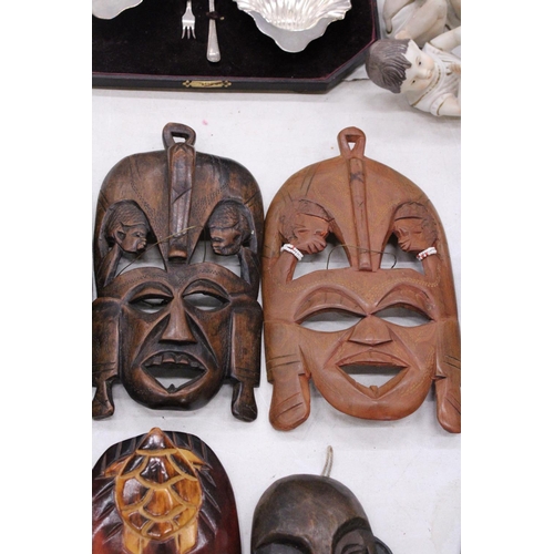 132 - FIVE AFRICAN HAND CARVED WOODEN MASKS - PLUS TWO SPEARS