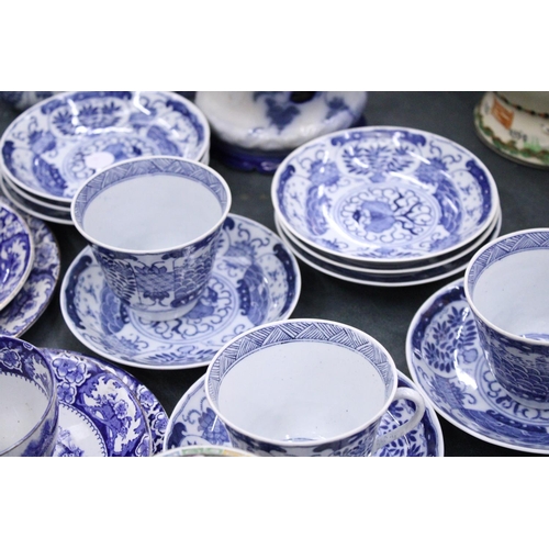 160 - A LARGE QUANTITY OF ORIENTAL STYLE BLUE AND WHITE TO INCLUDE CUPS,SAUCERS,SIDE PLATES PLUS A JUG AND... 