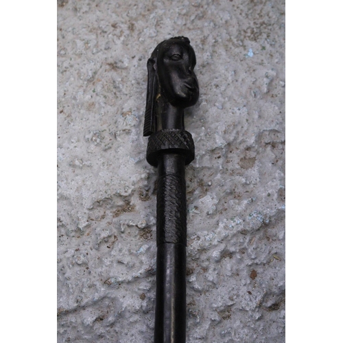 170 - AN ETHNIC AFRICAN BLACK WOODEN SPEAR - WITH CARVED HEAD DECORATION TO THE TOP