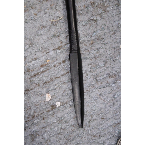 170 - AN ETHNIC AFRICAN BLACK WOODEN SPEAR - WITH CARVED HEAD DECORATION TO THE TOP