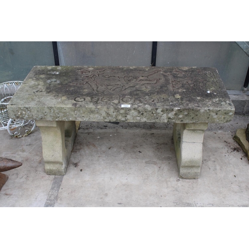 1523 - A NATURAL STONE HAND CARVED BENCH WITH 'THE JOKER' DETAIL AND PEDESTAL BASES (REQUIRES FIXING ONTO T... 