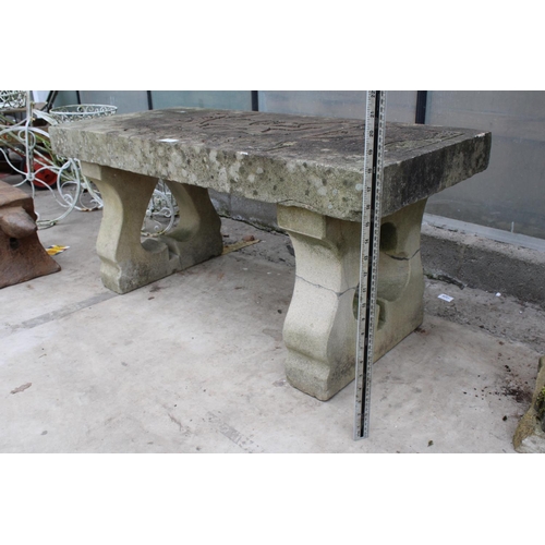 1523 - A NATURAL STONE HAND CARVED BENCH WITH 'THE JOKER' DETAIL AND PEDESTAL BASES (REQUIRES FIXING ONTO T... 