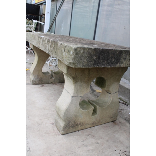 1523 - A NATURAL STONE HAND CARVED BENCH WITH 'THE JOKER' DETAIL AND PEDESTAL BASES (REQUIRES FIXING ONTO T... 