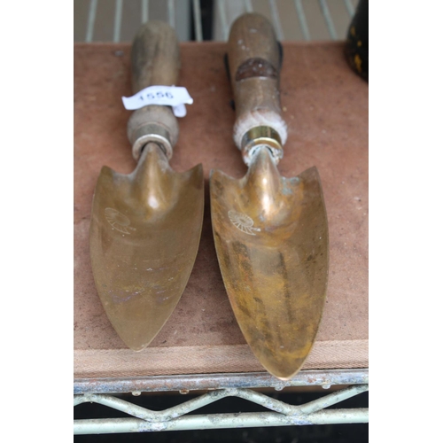 1556 - A PAIR OF BRONZE PKS GARDEN TROWELS