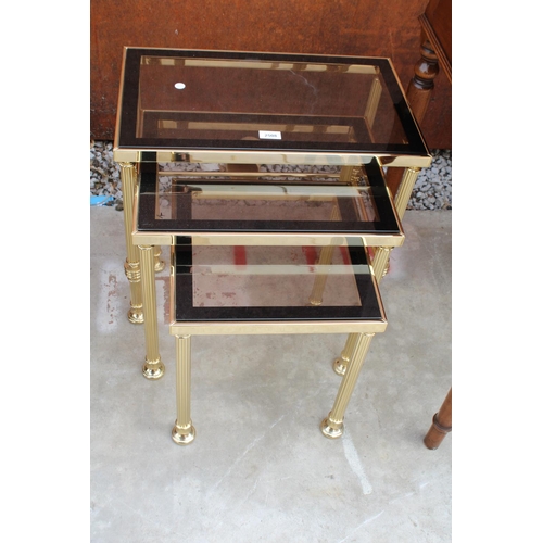 2508 - A MODERN GOLD COLOURED METAL FRAMED NEST OF 3 TABLES WITH SMOKED GLASS TOP