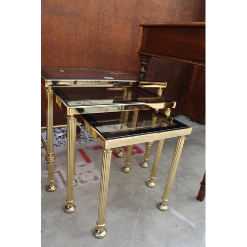 2508 - A MODERN GOLD COLOURED METAL FRAMED NEST OF 3 TABLES WITH SMOKED GLASS TOP