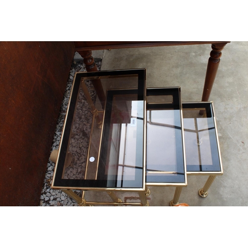 2508 - A MODERN GOLD COLOURED METAL FRAMED NEST OF 3 TABLES WITH SMOKED GLASS TOP