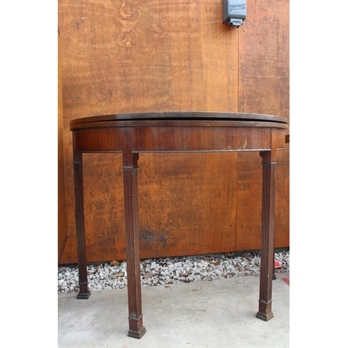 2512 - A 19TH CENTURY STYLE FOLD OVER GAMES TABLE ON FLUTED LEGS, 36