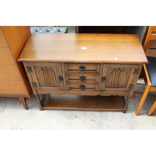 2541 - AN OAK JACOBEAN STYLE SIDE CABINET ENCLOSING 3 DRAWERS AND 2 CUPBOARDS WITH POT BOARD TO BASE ON TUR... 