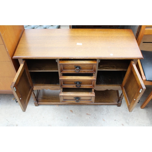 2541 - AN OAK JACOBEAN STYLE SIDE CABINET ENCLOSING 3 DRAWERS AND 2 CUPBOARDS WITH POT BOARD TO BASE ON TUR... 