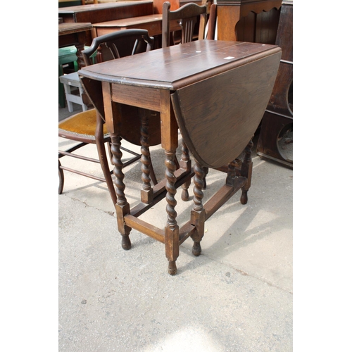 2573 - AN EARLY 20TH CENTURY OVAL OAK TABLE ON BARLEY-TWIST LEGS, 41