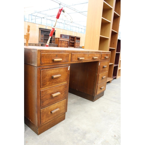 2773 - A MID 20TH CENTURY OAK TWIN PEDESTAL DESK ENCLOSING 8 DRAWERS, 54