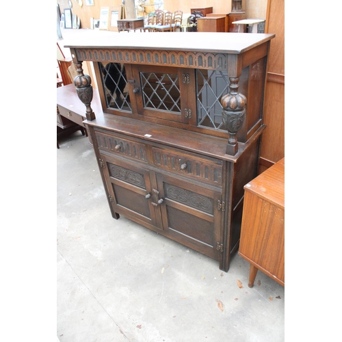 2782 - AN OAK JACOBEAN STYLE COURT CUPBOARD WITH GLAZED AND LEADED UPPER PORTION, 54