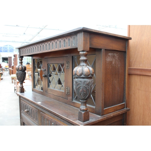 2782 - AN OAK JACOBEAN STYLE COURT CUPBOARD WITH GLAZED AND LEADED UPPER PORTION, 54