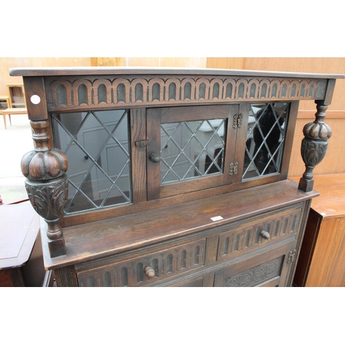 2782 - AN OAK JACOBEAN STYLE COURT CUPBOARD WITH GLAZED AND LEADED UPPER PORTION, 54