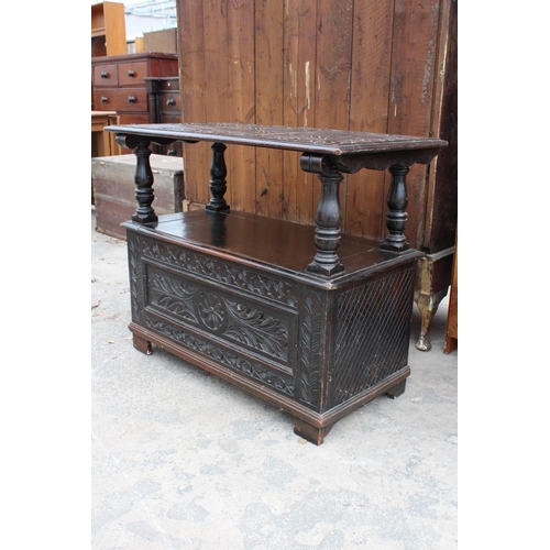 2801 - AN EARLY 20TH CENTURY OAK MONKS BENCH WITH CARVED PANELS