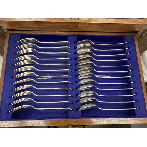 15 - A CASED CANTEEN OF CUTLERY WITH LIFT UP TOP CONTAINING KNIVES, FORKS AND CARVING EQUIPMENT, A DRAWER... 