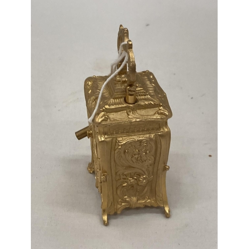 18 - A MINIATURE GILDED FRENCH CLOCK WITH KEY HEIGHT 3.5