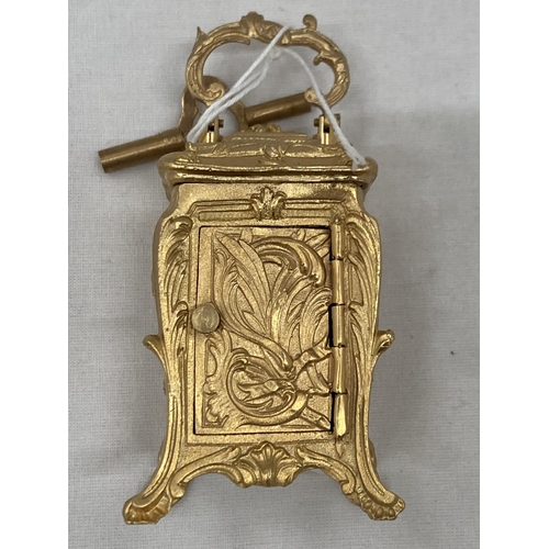 18 - A MINIATURE GILDED FRENCH CLOCK WITH KEY HEIGHT 3.5