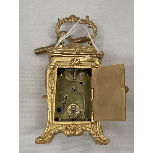 18 - A MINIATURE GILDED FRENCH CLOCK WITH KEY HEIGHT 3.5