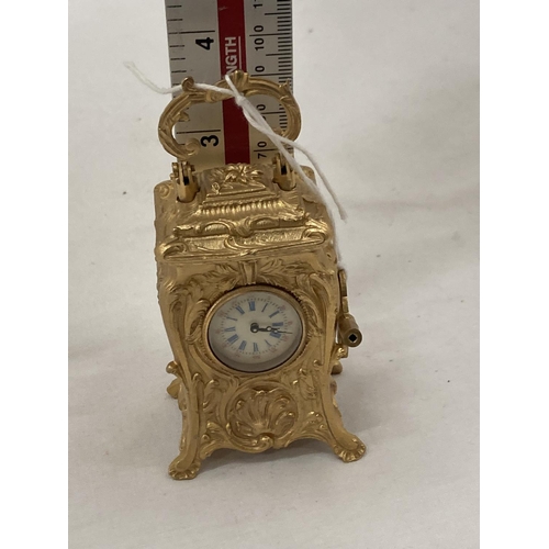 18 - A MINIATURE GILDED FRENCH CLOCK WITH KEY HEIGHT 3.5