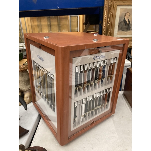 26 - A LARGE REVOLVING SQUARE WATCH STRAP DISPLAY CABINET WITH DRAWERS CONTAINING STRAPS