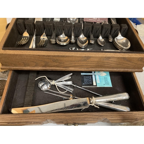 53 - A CASED PART CANTEEN OF CUTLERY WITH LIFT UP LID AND LOWER DRAWER CONTAINING A QUANTITY OF SHEFFIELD... 