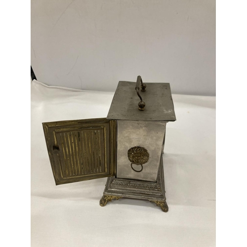 9 - AN OFFICER'S ALARM CLOCK WITH BRASS DECORATION AND LION HEADS TO THE SIDE