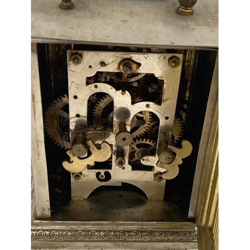 9 - AN OFFICER'S ALARM CLOCK WITH BRASS DECORATION AND LION HEADS TO THE SIDE