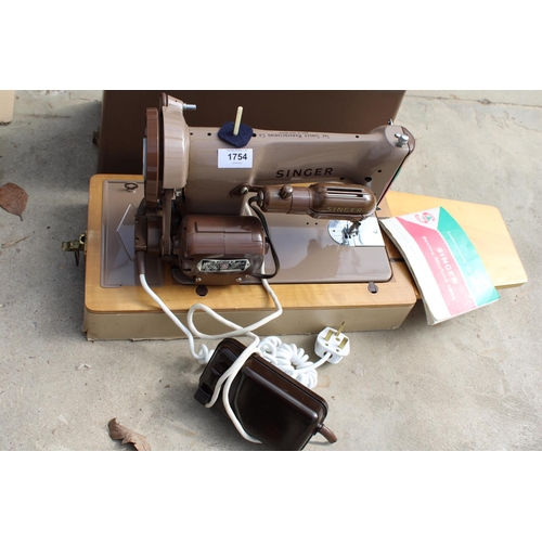 1754 - AN ELECTRIC SINGER SEWING MACHINE WITH FOOT PEDAL AND CARRY CASE