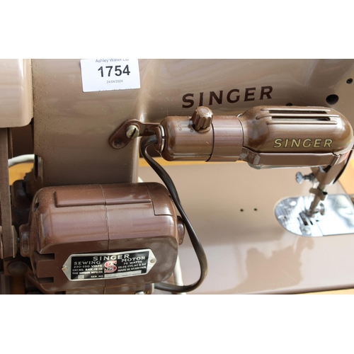 1754 - AN ELECTRIC SINGER SEWING MACHINE WITH FOOT PEDAL AND CARRY CASE