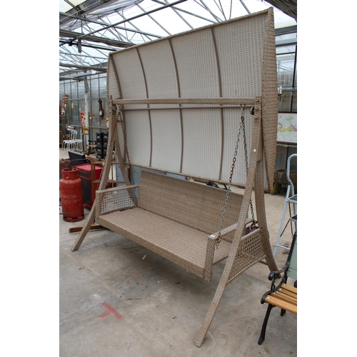 1765 - A LARGE THREE SEATER RATTAN SWING SEAT WITH CANOPY