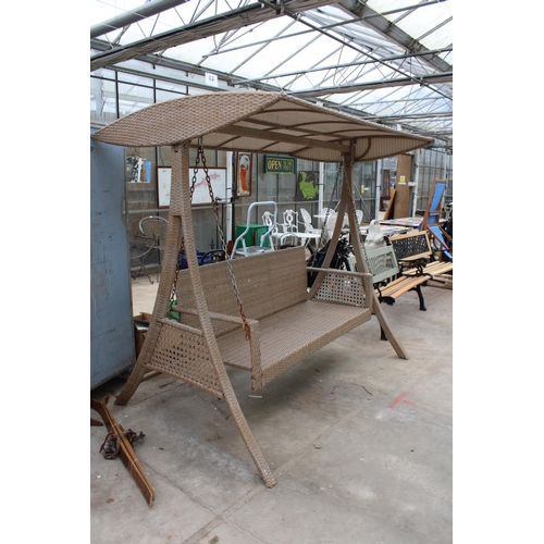 1765 - A LARGE THREE SEATER RATTAN SWING SEAT WITH CANOPY