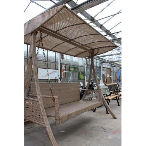 1765 - A LARGE THREE SEATER RATTAN SWING SEAT WITH CANOPY