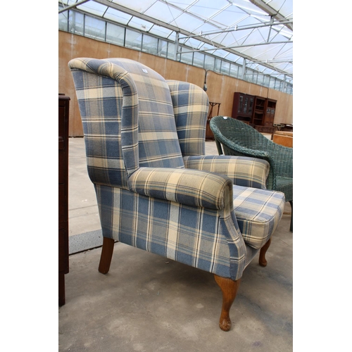 2857 - A MODERN CHECK WINGED FIRESIDE CHAIR ON FRONT CABRIOLE LEGS