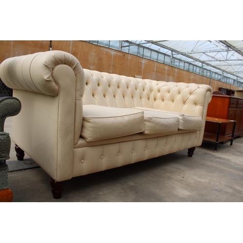 2863 - A MODERN CREAM FAUX LEATHER CHESTERFIELD THREE SEATER SETTEE