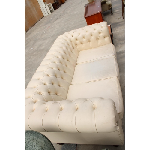 2863 - A MODERN CREAM FAUX LEATHER CHESTERFIELD THREE SEATER SETTEE