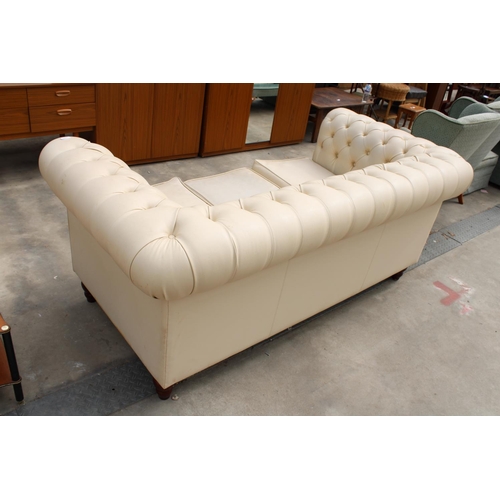 2863 - A MODERN CREAM FAUX LEATHER CHESTERFIELD THREE SEATER SETTEE