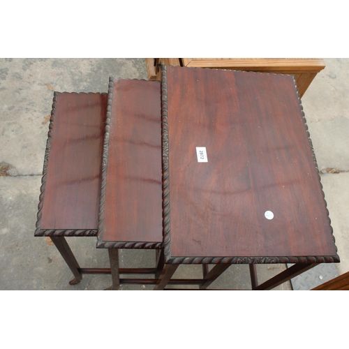 2872 - A MAHOGANY NEST OF THREE ROPE EDGE TABLES